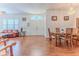 Open living space with hardwood floors, chandeliers, and large windows offering natural light at 11389 Mcnally Dr, Spring Hill, FL 34609