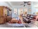 Comfortable living room features hardwood floors, ceiling fan, and a large built-in entertainment center at 11389 Mcnally Dr, Spring Hill, FL 34609