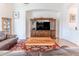Comfortable living room features hardwood floors, a ceiling fan, and a large built-in entertainment center at 11389 Mcnally Dr, Spring Hill, FL 34609