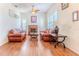 Cozy living room featuring a fireplace, hardwood floors, and comfortable seating arrangement at 11389 Mcnally Dr, Spring Hill, FL 34609