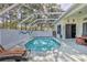 Enclosed pool featuring a screened enclosure, clear water, and a lounge chair for relaxing outdoors at 11389 Mcnally Dr, Spring Hill, FL 34609