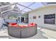 Enclosed pool with a circular seating arrangement, screened enclosure, and inviting clear water for outdoor enjoyment at 11389 Mcnally Dr, Spring Hill, FL 34609