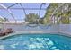 Enclosed pool featuring screened enclosure, clear water, and privacy, creating a serene outdoor oasis at 11389 Mcnally Dr, Spring Hill, FL 34609