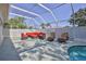 Enclosed pool area with ample seating, screened enclosure, and inviting clear water for outdoor relaxation at 11389 Mcnally Dr, Spring Hill, FL 34609