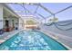 Enclosed pool featuring screened-in lanai, clear water, and comfortable seating for relaxation and enjoyment at 11389 Mcnally Dr, Spring Hill, FL 34609