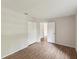 Neutral bedroom with hardwood floors, closet, and view of the trees at 11751 Key Lime Dr, New Port Richey, FL 34654