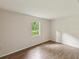 Inviting bedroom with neutral walls, wood-look flooring, and a window at 11751 Key Lime Dr, New Port Richey, FL 34654