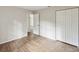 Bright bedroom with wood-look flooring and closet at 11751 Key Lime Dr, New Port Richey, FL 34654