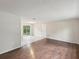 Spacious living room with hardwood floors and sliding doors leading to the backyard at 11751 Key Lime Dr, New Port Richey, FL 34654