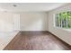 Bright living room featuring hardwood floors and a large window at 11751 Key Lime Dr, New Port Richey, FL 34654