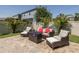 Cozy backyard patio with comfortable seating around a modern fire pit, perfect for entertaining at 12750 Tikal Way, Trinity, FL 34655