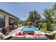 Inviting backyard with a sparkling pool, outdoor dining, and comfortable seating area for relaxation at 12750 Tikal Way, Trinity, FL 34655