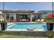 Inviting backyard pool with lounge chairs, a patio, and a well-manicured lawn at 12750 Tikal Way, Trinity, FL 34655