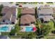 Aerial view of a private backyard oasis with a sparkling pool, lounge area, and manicured lawn at 12750 Tikal Way, Trinity, FL 34655