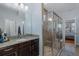 Bright bathroom with a spacious glass-enclosed shower and dark wood vanity at 12750 Tikal Way, Trinity, FL 34655
