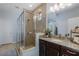 Modern bathroom featuring a glass shower, granite countertop, and neutral tile at 12750 Tikal Way, Trinity, FL 34655