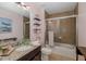 Bathroom featuring tile, a shower-tub combo with a glass door, and a granite vanity at 12750 Tikal Way, Trinity, FL 34655