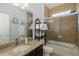 Well-lit bathroom features granite countertop, glass-enclosed shower, and tile walls at 12750 Tikal Way, Trinity, FL 34655