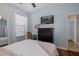 Comfortable bedroom with a large window, wooden dresser, and relaxing armchair at 12750 Tikal Way, Trinity, FL 34655