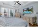 Inviting bedroom with a ceiling fan, pool views, and an entertainment center at 12750 Tikal Way, Trinity, FL 34655