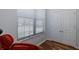 Relaxing room with a comfortable red massage chair in front of a sunny window and closet at 12750 Tikal Way, Trinity, FL 34655