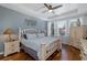 Airy bedroom with a ceiling fan, tray ceilings, and an outdoor pool view at 12750 Tikal Way, Trinity, FL 34655