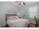 Comfortable bedroom with soft colors, hardwood floors, a full-length mirror and ceiling fan at 12750 Tikal Way, Trinity, FL 34655