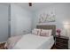 Cozy bedroom featuring a plush bed, soft pink accents, and a decorative floral painting at 12750 Tikal Way, Trinity, FL 34655