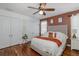 Spacious bedroom featuring a ceiling fan, hardwood floors, and a large closet at 12750 Tikal Way, Trinity, FL 34655