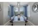 Dining room with a long table, seating for eight, and natural light from the windows at 12750 Tikal Way, Trinity, FL 34655