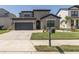 Charming two-story home with a well-maintained lawn, manicured landscaping, and a welcoming front entrance at 12750 Tikal Way, Trinity, FL 34655