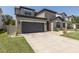 Charming two-story home with a well-manicured lawn and a convenient two-car garage at 12750 Tikal Way, Trinity, FL 34655
