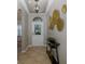 Inviting foyer featuring stylish decor, elegant lighting, and tiled flooring at 12750 Tikal Way, Trinity, FL 34655