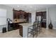 Spacious kitchen with dark wood cabinetry, granite countertops, and stainless steel appliances at 12750 Tikal Way, Trinity, FL 34655