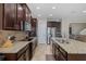 Well-equipped kitchen featuring a large island, granite counters, and stainless steel appliances at 12750 Tikal Way, Trinity, FL 34655