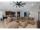 Open concept living space with a large sectional sofa and view of the kitchen at 12750 Tikal Way, Trinity, FL 34655