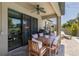 Covered patio with ceiling fan, dining set, grill, and lounge chair overlooking the pool at 12750 Tikal Way, Trinity, FL 34655