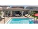Inviting backyard featuring a refreshing pool, outdoor dining area, and lounge chairs for relaxation at 12750 Tikal Way, Trinity, FL 34655