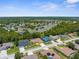 An aerial perspective of a residential community, highlighting homes with swimming pools and proximity to lush green spaces at 13155 Cori Loop, Spring Hill, FL 34609