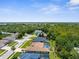 An aerial view captures a lush neighborhood with landscaped yards and sparkling pools, creating a desirable living environment at 13155 Cori Loop, Spring Hill, FL 34609