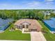 Expansive aerial shot of a well-maintained single-story home surrounded by a lush green lawn and mature trees at 13155 Cori Loop, Spring Hill, FL 34609