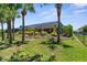 The backyard showcases a screened-in pool area surrounded by lush landscaping for added privacy and beauty at 13155 Cori Loop, Spring Hill, FL 34609