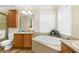 Bright bathroom featuring a garden tub, a glass shower, and a neutral color palette at 13155 Cori Loop, Spring Hill, FL 34609