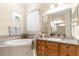 Bright bathroom with a garden tub, natural light, and vanity sink for a relaxing experience at 13155 Cori Loop, Spring Hill, FL 34609