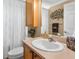 Well-lit bathroom with a large mirror, toilet, and vanity with decor at 13155 Cori Loop, Spring Hill, FL 34609