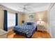 Comfortable bedroom features hardwood floors, natural light, and a ceiling fan at 13155 Cori Loop, Spring Hill, FL 34609