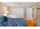 Bright bedroom features a comfortable bed, closet, and hardwood floors for a cozy and inviting space at 13155 Cori Loop, Spring Hill, FL 34609