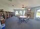Community library features a fireplace, bookshelves, and a large table for gathering at 13155 Cori Loop, Spring Hill, FL 34609