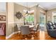 Cozy dining area with a wooden table, stylish chairs, and an attractive view of the pool area at 13155 Cori Loop, Spring Hill, FL 34609