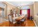 Dining room features chandelier, wood table with seating for six, and large window at 13155 Cori Loop, Spring Hill, FL 34609